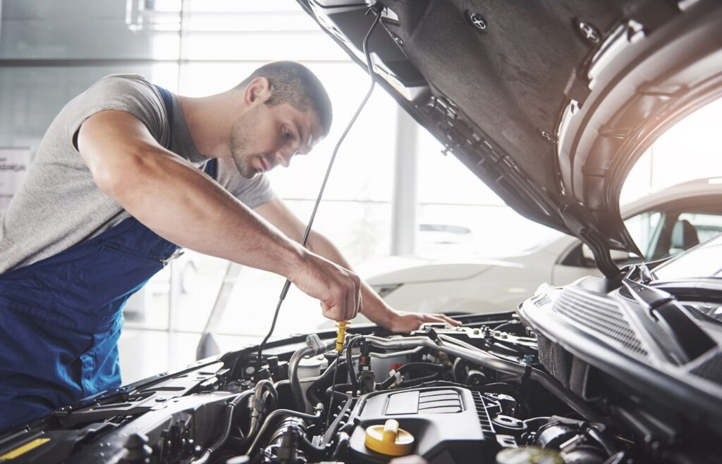 Mechanic repairing car engine