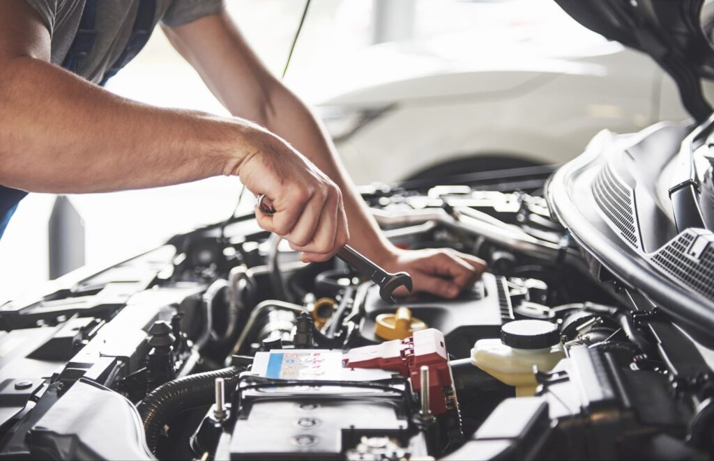 A man fixes a car engine