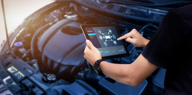 A man carries out diagnostics of a car holding a tablet in his hands