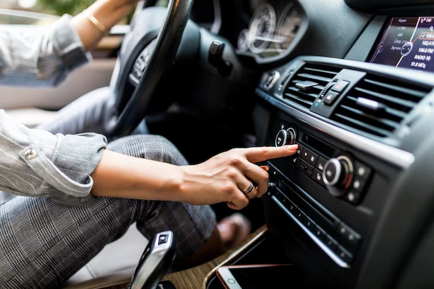 A man presses a button on the gear panel in a car