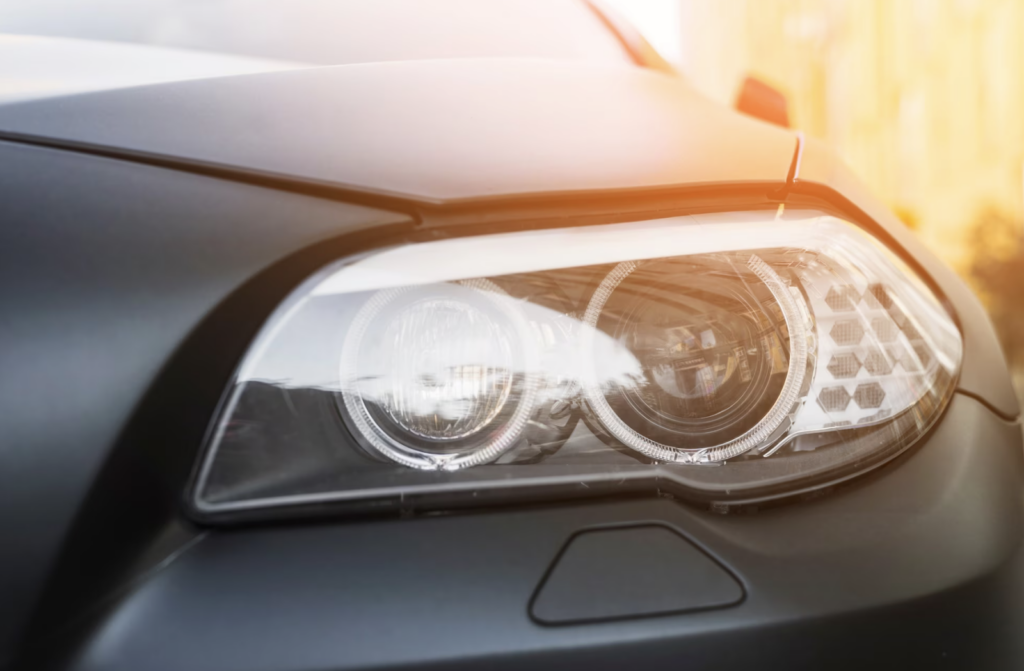 Modern led headlights of a dark car on the street