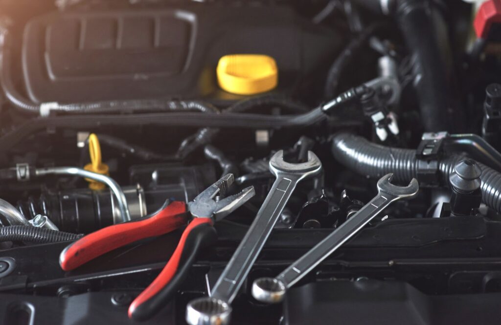 Close up of tools next to the car engine